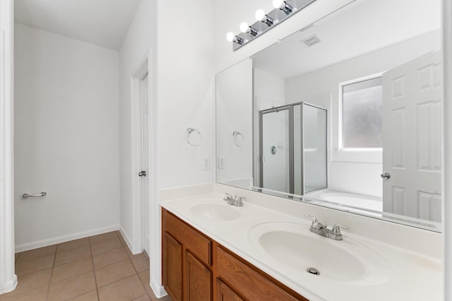 bathroom featuring tile patterned floors, visible vents, a stall shower, and a sink