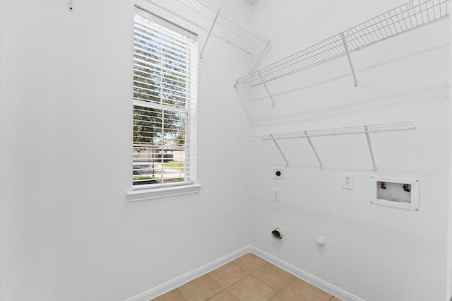 laundry area featuring hookup for a washing machine, baseboards, laundry area, electric dryer hookup, and hookup for a gas dryer