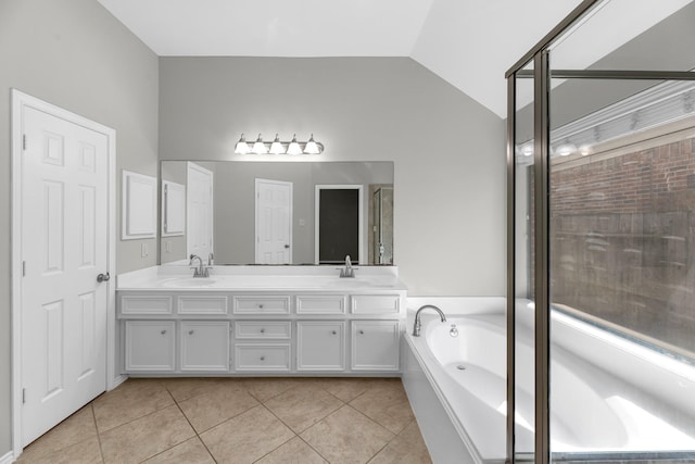 full bathroom with lofted ceiling, double vanity, a sink, tile patterned floors, and a bath