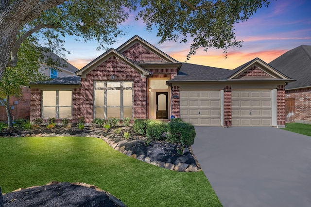 view of front facade featuring brick siding, concrete driveway, roof with shingles, a lawn, and an attached garage