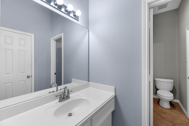 bathroom featuring visible vents, toilet, tile patterned flooring, baseboards, and vanity