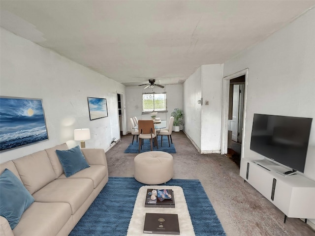 living area with concrete flooring and ceiling fan