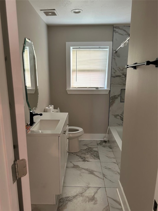 bathroom with toilet, vanity, visible vents, baseboards, and marble finish floor