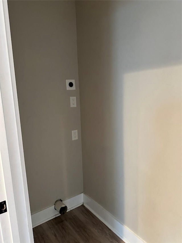 laundry area with baseboards, laundry area, dark wood-style flooring, and hookup for an electric dryer