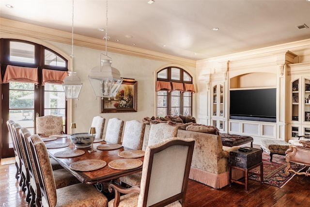 dining room featuring ornamental molding, french doors, wood-type flooring, and built in features