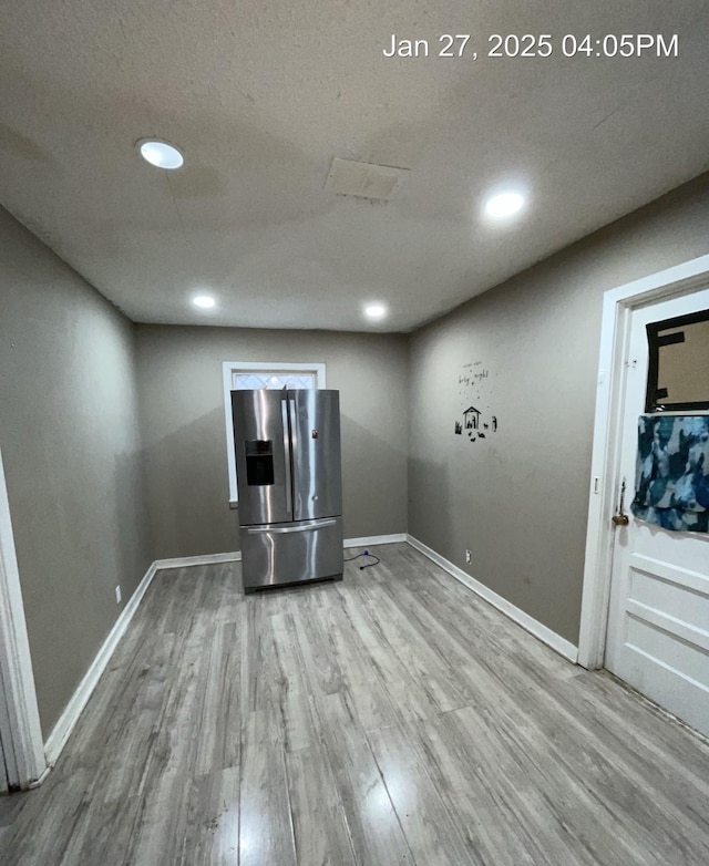 unfurnished room with recessed lighting, baseboards, and wood finished floors