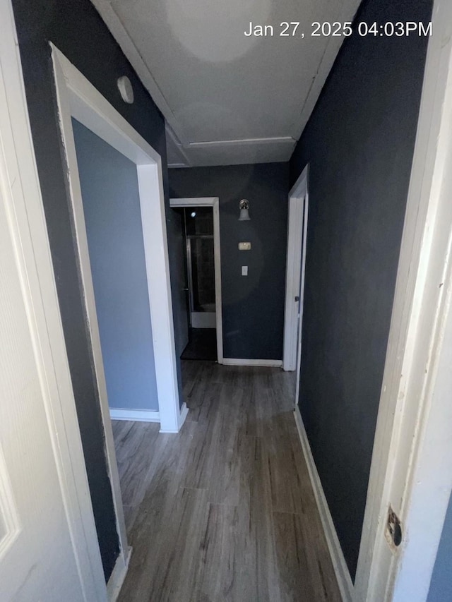 hall with wood finished floors and baseboards