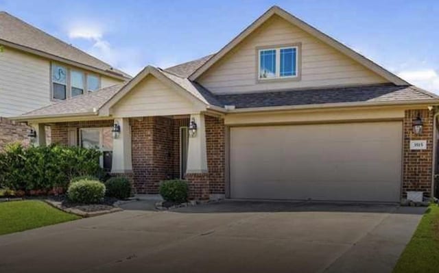 view of front facade with a garage, brick siding, and concrete driveway