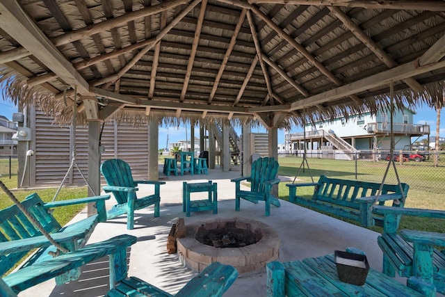 view of patio / terrace featuring a gazebo, fence, and an outdoor fire pit