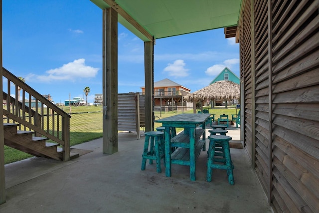 view of patio with outdoor dining area and fence