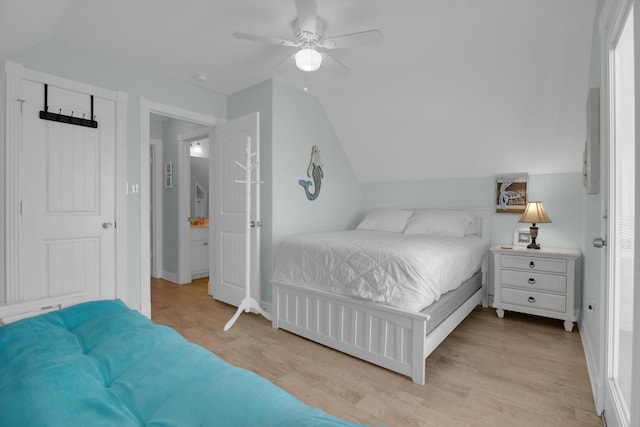 bedroom featuring baseboards, lofted ceiling, ceiling fan, and light wood finished floors