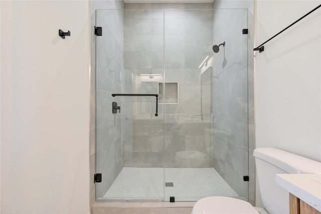 bathroom with a stall shower and toilet