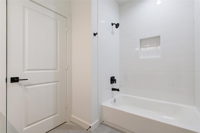 bathroom with baseboards and shower / bathtub combination