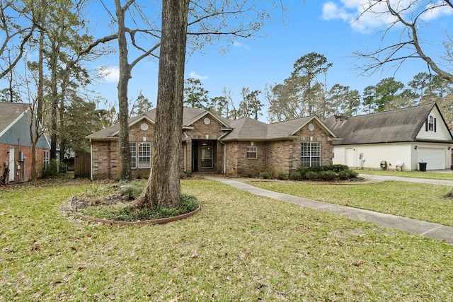 view of front of home with driveway, brick siding, and a front lawn