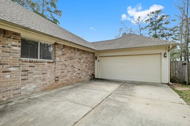 exterior space with concrete driveway and fence