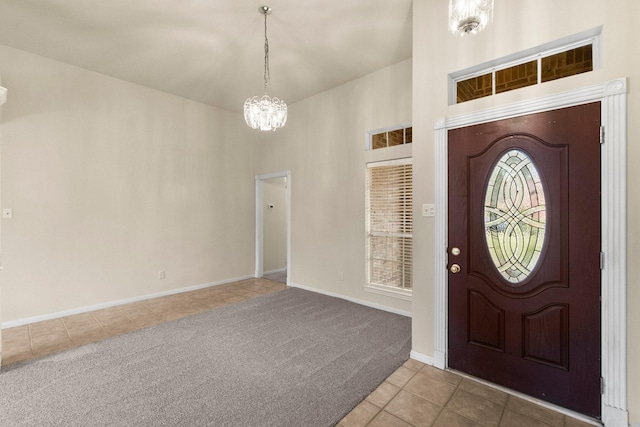 tiled foyer with carpet flooring, baseboards, an inviting chandelier, and a towering ceiling