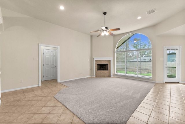 unfurnished living room with light tile patterned floors, a ceiling fan, recessed lighting, and a fireplace