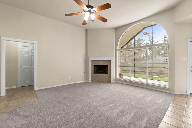 unfurnished living room with carpet flooring, plenty of natural light, and a fireplace