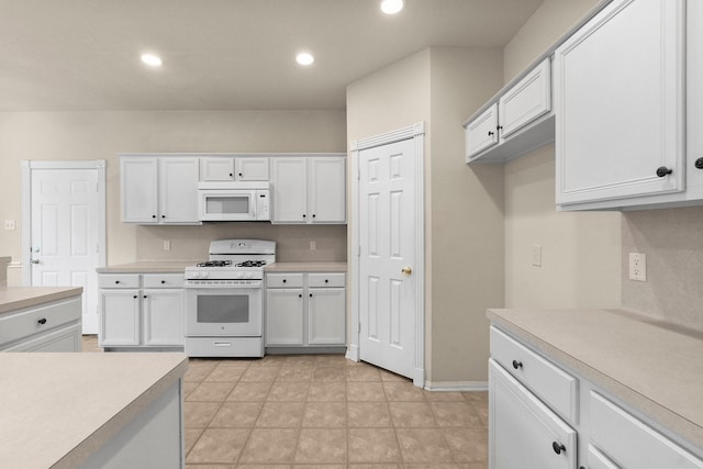 kitchen featuring white cabinetry, recessed lighting, white appliances, light countertops, and baseboards