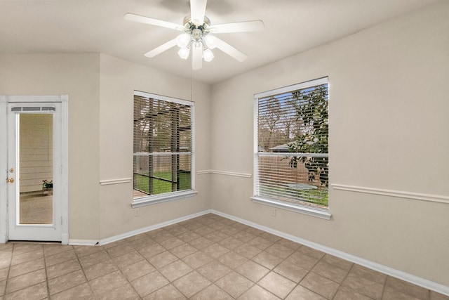 spare room featuring baseboards and a ceiling fan