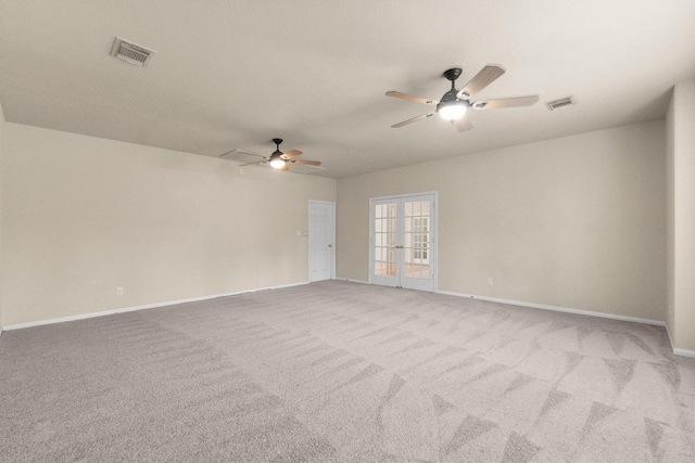 unfurnished room with visible vents, carpet flooring, french doors, and baseboards