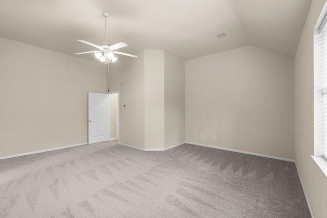 carpeted empty room with visible vents, ceiling fan, baseboards, and lofted ceiling