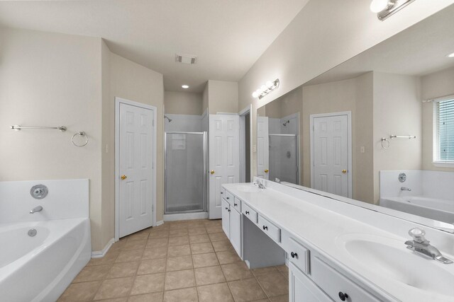 full bathroom featuring visible vents, a shower stall, a garden tub, double vanity, and a sink