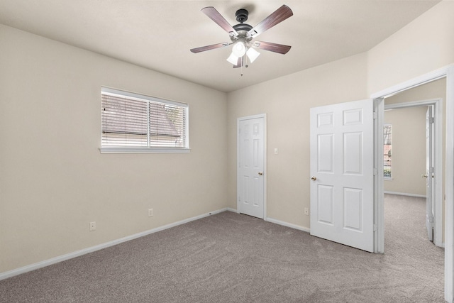 unfurnished bedroom featuring carpet flooring, baseboards, and ceiling fan