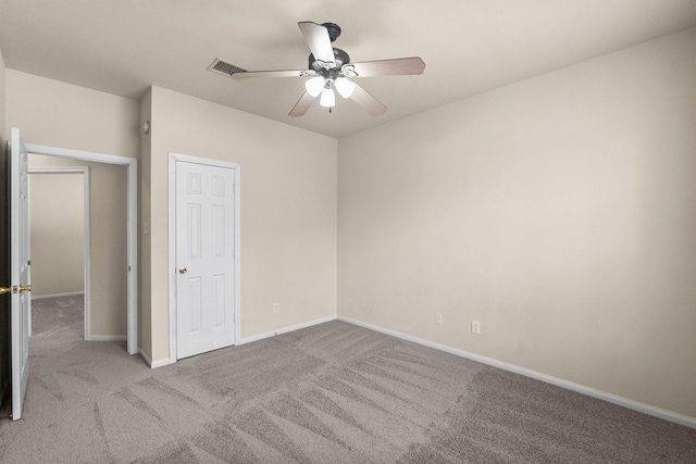 unfurnished bedroom featuring visible vents, baseboards, ceiling fan, and carpet flooring