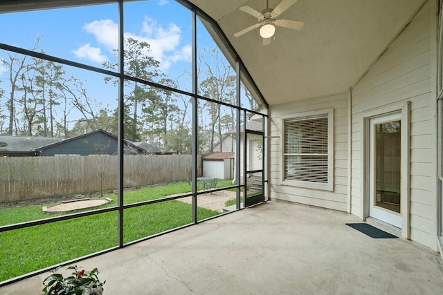 unfurnished sunroom featuring lofted ceiling and ceiling fan