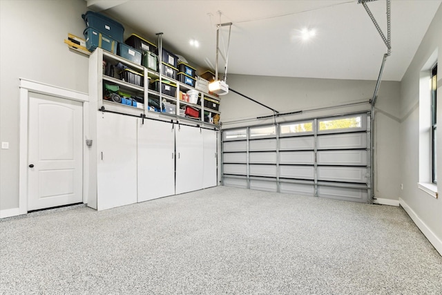 garage with a garage door opener and baseboards