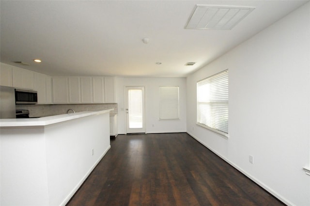 kitchen featuring dark wood-style floors, visible vents, light countertops, white cabinets, and appliances with stainless steel finishes