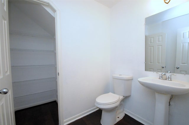 bathroom featuring baseboards and toilet