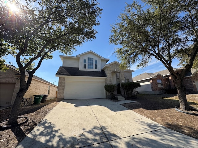 traditional-style home with a garage, concrete driveway, and brick siding