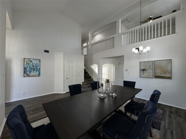 dining room featuring dark wood finished floors, a notable chandelier, stairway, and baseboards