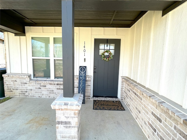 view of exterior entry with brick siding