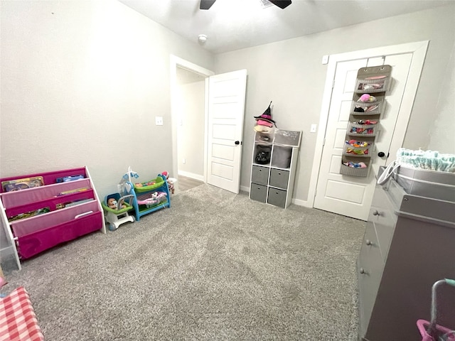 rec room featuring carpet floors, ceiling fan, and baseboards