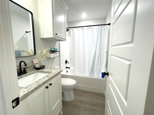 bathroom with toilet, shower / bath combo with shower curtain, wood finished floors, and vanity