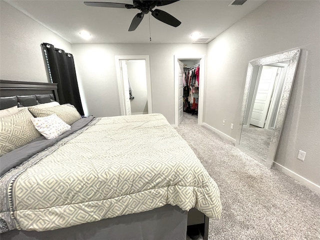 carpeted bedroom with baseboards, a spacious closet, visible vents, and ceiling fan