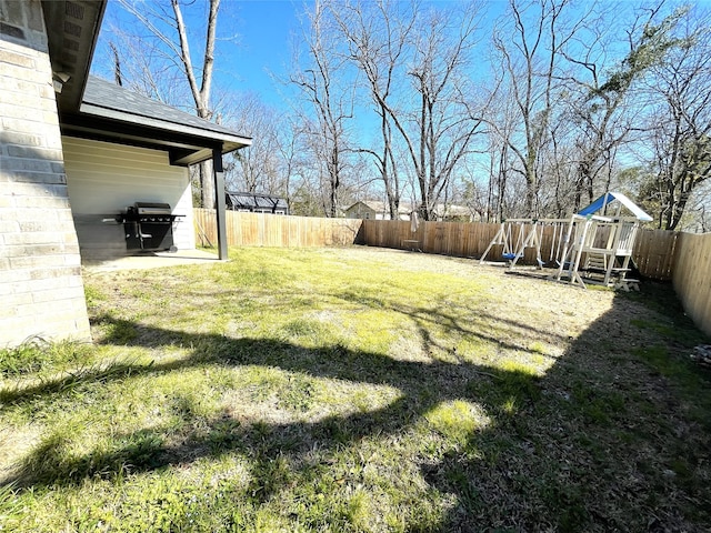 view of yard featuring a playground and a fenced backyard