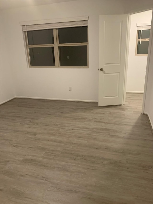 empty room with wood finished floors and baseboards