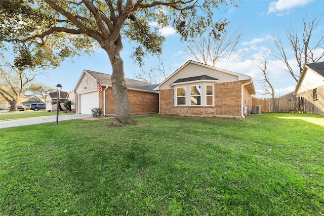 single story home featuring brick siding, fence, concrete driveway, a front yard, and central AC unit