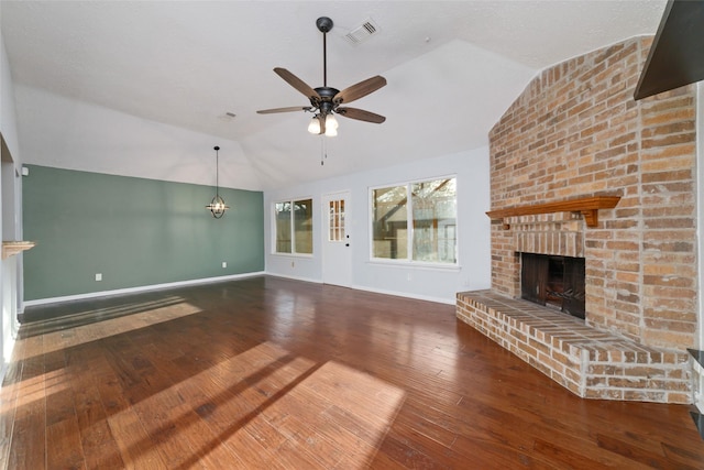 unfurnished living room with visible vents, a brick fireplace, hardwood / wood-style flooring, and vaulted ceiling