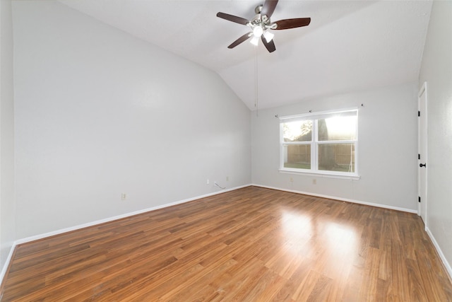 spare room featuring ceiling fan, baseboards, lofted ceiling, and wood finished floors