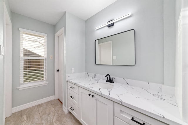 bathroom featuring baseboards and vanity