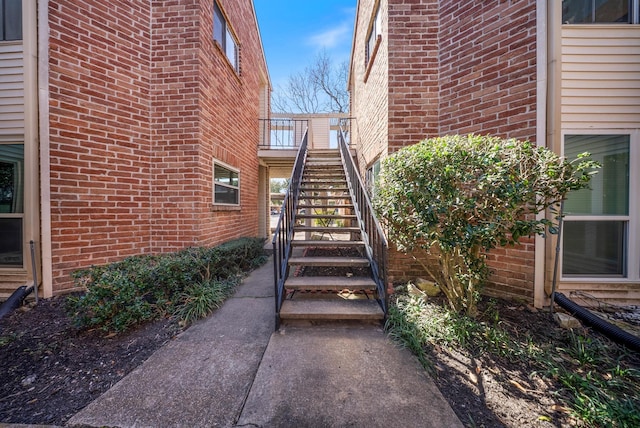 entrance to property featuring brick siding