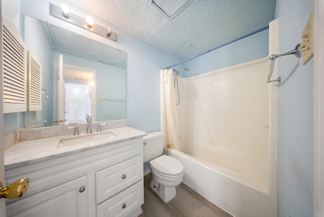 full bath with a textured ceiling, toilet, wood finished floors, vanity, and shower / bathtub combination with curtain