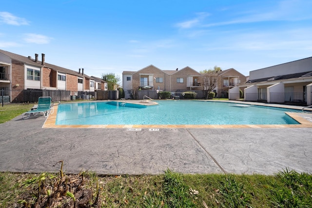 community pool with a residential view and fence