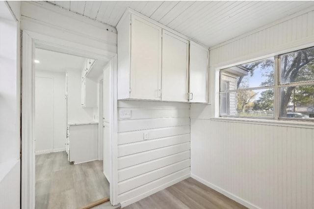 washroom with light wood finished floors and baseboards