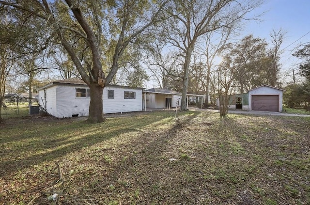 ranch-style home featuring a garage, brick siding, an outbuilding, crawl space, and a front yard